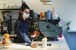 Vrouw serveert koffie bij Doppio